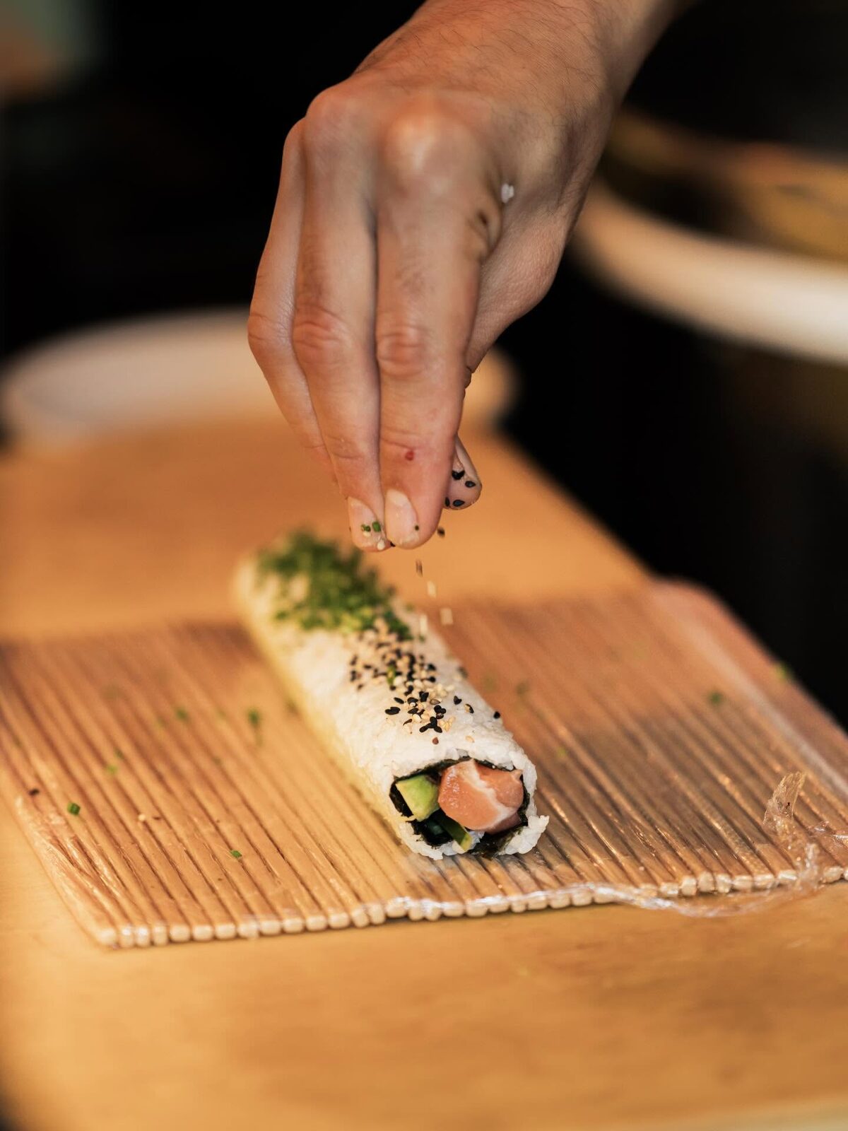 Rolling maki by hand on the bamboo mat